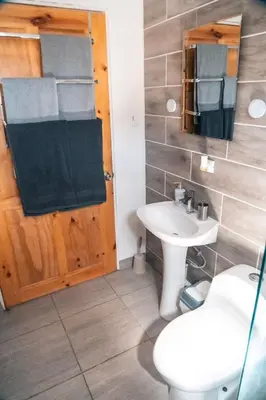 a bathroom with a sink and a toilet and a mirror at Fruta mango # 1 in Playa Guacalillo