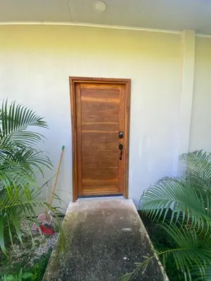 a wooden door on the side of a building at Ona Casita 1 in Cuajiniquil