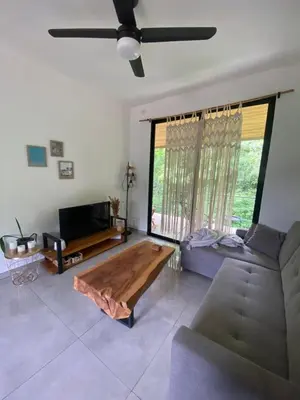 a living room with a couch and a coffee table at Ona Casita 1 in Cuajiniquil