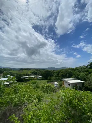 a view of a field with houses and a cloudy sky at Ona Casita 1 in Cuajiniquil