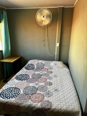 a bed with a quilt on it in a bedroom at Manzano lodge in Desamparados