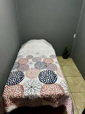 a bed with a quilt on it in a room at Manzano lodge in Desamparados