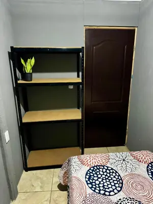 a small room with a bunk bed and a door at Manzano lodge in Desamparados