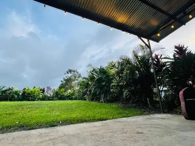 a view from the porch of a house with a green lawn at Teyú Green Cottage in Cuatro Esquinas