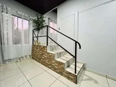 a staircase in a house with a plant at Teyú Green Cottage in Cuatro Esquinas