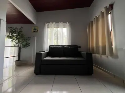 a living room with a couch and a window at Teyú Green Cottage in Cuatro Esquinas