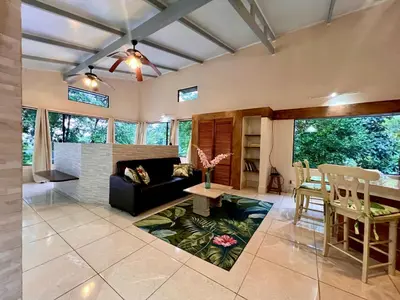 a living room with a couch and a table at Zen Zaru Free MA Park Tour & Breakfast in Manuel Antonio