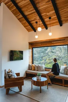 a living room with couches and a large window at MAUMA Forest Villas - Fireplace & Amazing Views in Monteverde Costa Rica