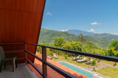 a balcony with a view of the mountains at Bongalows Chepe Araya in Pejibaye