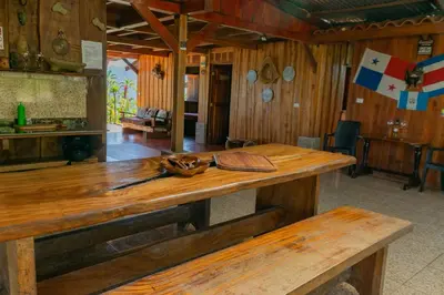 a wooden table in a room with a wooden practition at Cabaña Rustica Chepe Araya in Pejibaye