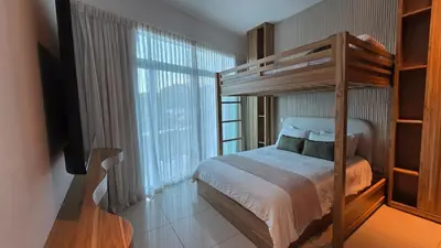 a bedroom with a bunk bed and a large window at Luxury Apartment by the Beach! in Santa Cruz