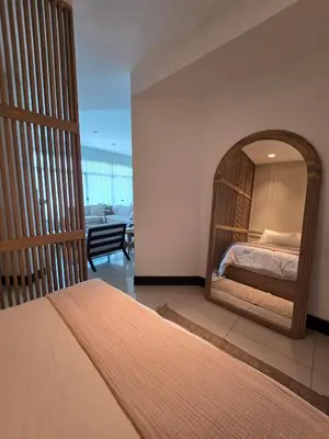 a bedroom with a bed and a mirror at Luxury Apartment by the Beach! in Santa Cruz