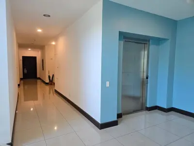 a hallway with blue walls and a glass door at Luxury Apartment by the Beach! in Santa Cruz