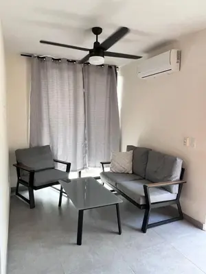 a living room with two chairs and a ceiling fan at Ona Casita 2 in Matapalo