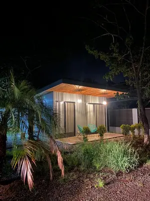 a house with two chairs in front of it at night at Ona Casita 2 in Matapalo