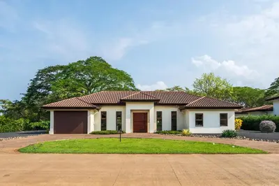 a white house with a red roof at La Perla Cozy 3BR sleeps 10 Hacienda Pinilla in Santa Cruz