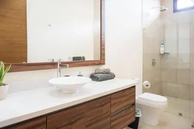 a bathroom with a sink and a toilet at La Perla Cozy 3BR sleeps 10 Hacienda Pinilla in Santa Cruz
