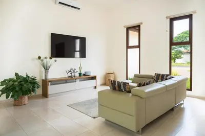 a living room with a couch and a tv at La Perla Cozy 3BR sleeps 10 Hacienda Pinilla in Santa Cruz