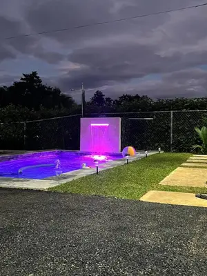 a pink fountain in a park at night at Quinta La Esperanza in Chachagua