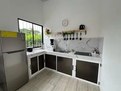 a kitchen with a refrigerator and a sink at Quinta La Esperanza in Chachagua