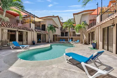 a villa with a swimming pool and two lounge chairs at 2 BD Condo with Pool in Ocotal