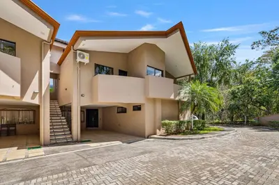 a large house with a courtyard in front of it at 2 BD Condo with Pool in Ocotal