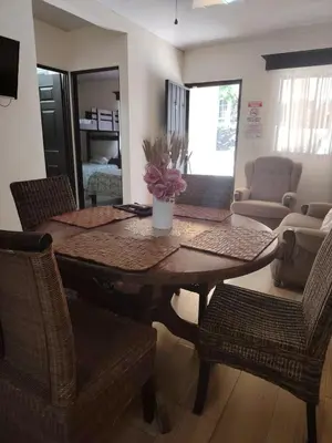 a dining table and chairs in a living room at SJO airport eco-Escape, Villa Lapa 5 & Pool in Tivives