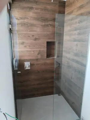 a shower with wooden walls and a glass door at New House w Pool close to beach! in Esterillos Este
