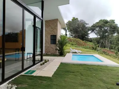 an external view of a house with a swimming pool at New House w Pool close to beach! in Esterillos Este