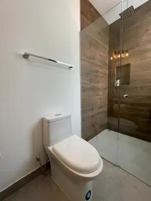 a bathroom with a toilet and a shower at New House w Pool close to beach! in Esterillos Este