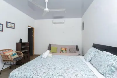 a bedroom with a large bed and a chair at Casa Potrero in Potrero