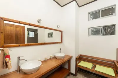 a bathroom with two sinks and a mirror at Casa Potrero in Potrero