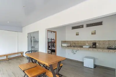 a dining room with a wooden table and chairs at Casa Potrero in Potrero