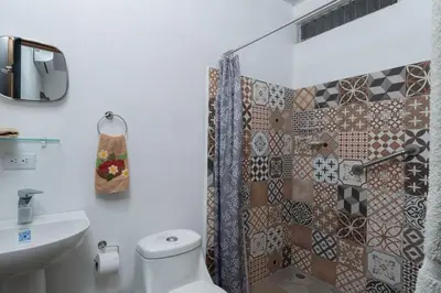 a bathroom with a shower and a toilet and a sink at Casa Potrero in Potrero