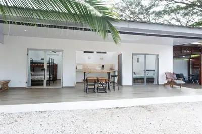 a patio with a table and chairs in a house at Casa Potrero in Potrero
