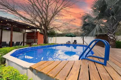 a swimming pool on a deck with a wooden deck at Casa Potrero in Potrero