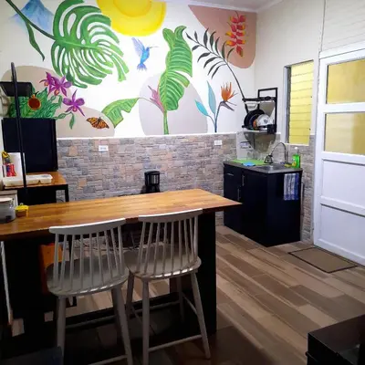a kitchen with a wooden table and two chairs at 2 Room 1 ba close to SJO airport, Poás and waterfalls in Alajuela City