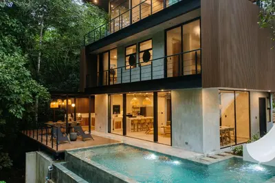 an exterior view of a house with a swimming pool at Manuel Antonio Tree House Villas - 3 Bedrooms in Quepos