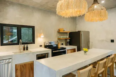 a kitchen with a large island in the middle at Manuel Antonio Tree House Villas - 3 Bedrooms in Quepos