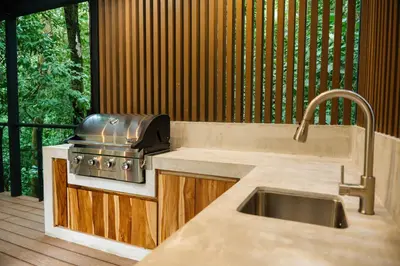 a kitchen with a stove and a sink at Manuel Antonio Tree House Villas - 3 Bedrooms in Quepos