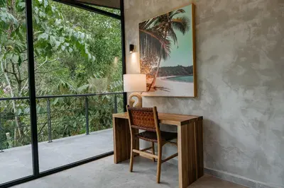 a desk with a chair in a room with a window at Manuel Antonio Tree House Villas - 3 Bedrooms in Quepos