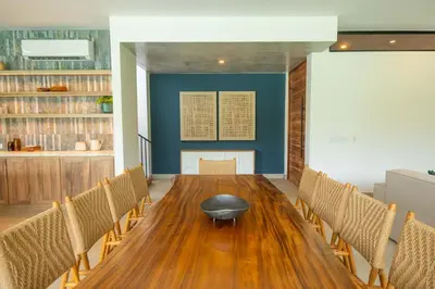 a conference room with a wooden table and chairs at Xanadu Arenal Villa in Fortuna