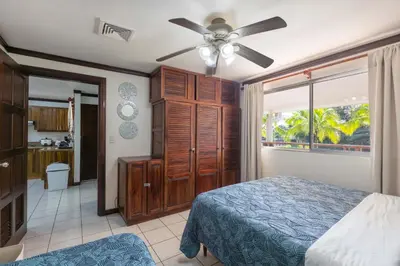 a bedroom with a bed and a ceiling fan at Casa del Sol - Poolside Villa in Quepos
