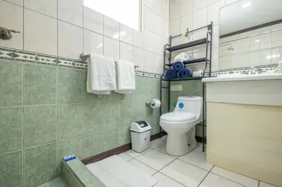 a bathroom with a toilet and a sink at Casa del Sol - Poolside Villa in Quepos