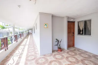 an empty hallway with a door and a potted plant at Casa del Sol - Poolside Villa in Quepos