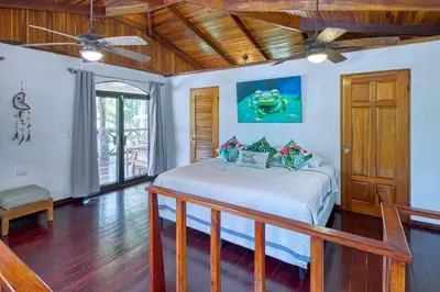a bedroom with a bed and a ceiling fan at Mariposa Monarca in Esterillos
