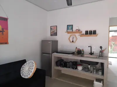 a kitchen with a refrigerator and a counter with a sink at Moon Home Sand #2 in Playa hermosa
