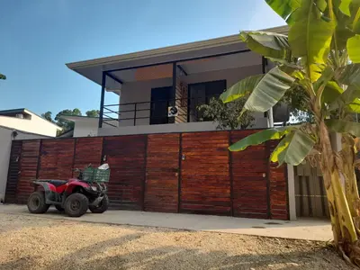 a red atv parked in front of a house at Moon Home Sand #2 in Playa hermosa