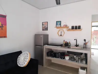 a kitchen with a refrigerator and a counter with a sink at Moon Home Sand #2 in Playa hermosa