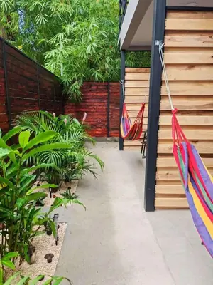 a patio with two umbrellas hanging from a building at Moon Home Sand #2 in Playa hermosa